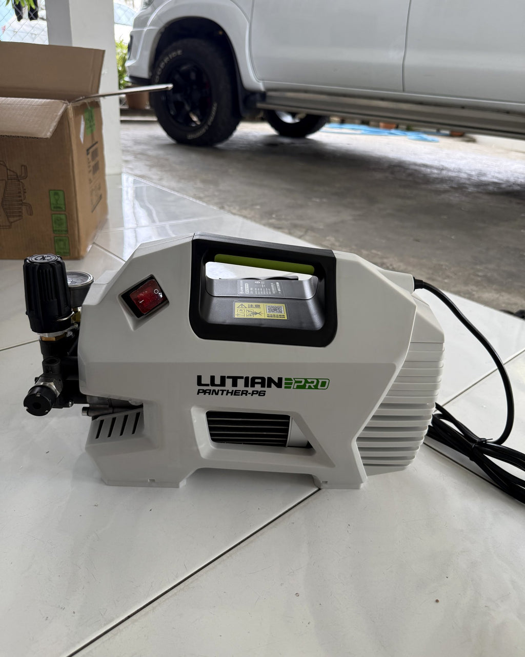 Lutian Panther P6 Pro on a tiled porch in Bintulu, with a Hilux behind